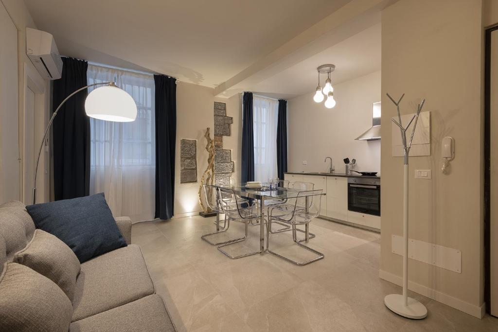 a living room with a couch and a glass table at La Sorgente in Como