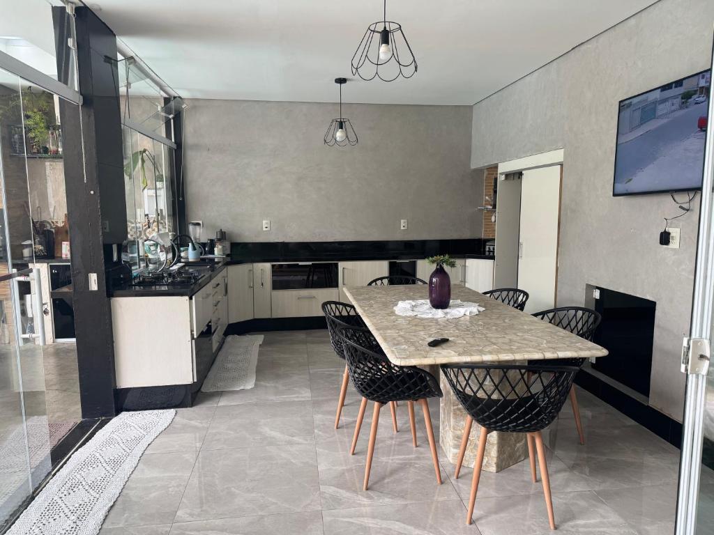 a kitchen with a table and chairs in a room at Espaço Varanda in Sao Paulo
