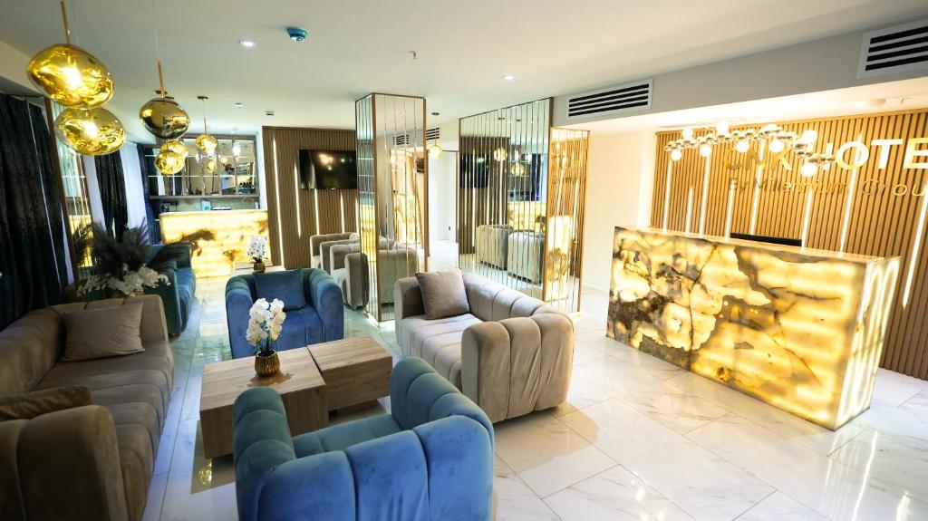 a lobby with couches and chairs in a store at CNK Hotel By Millennium Group in Tbilisi City