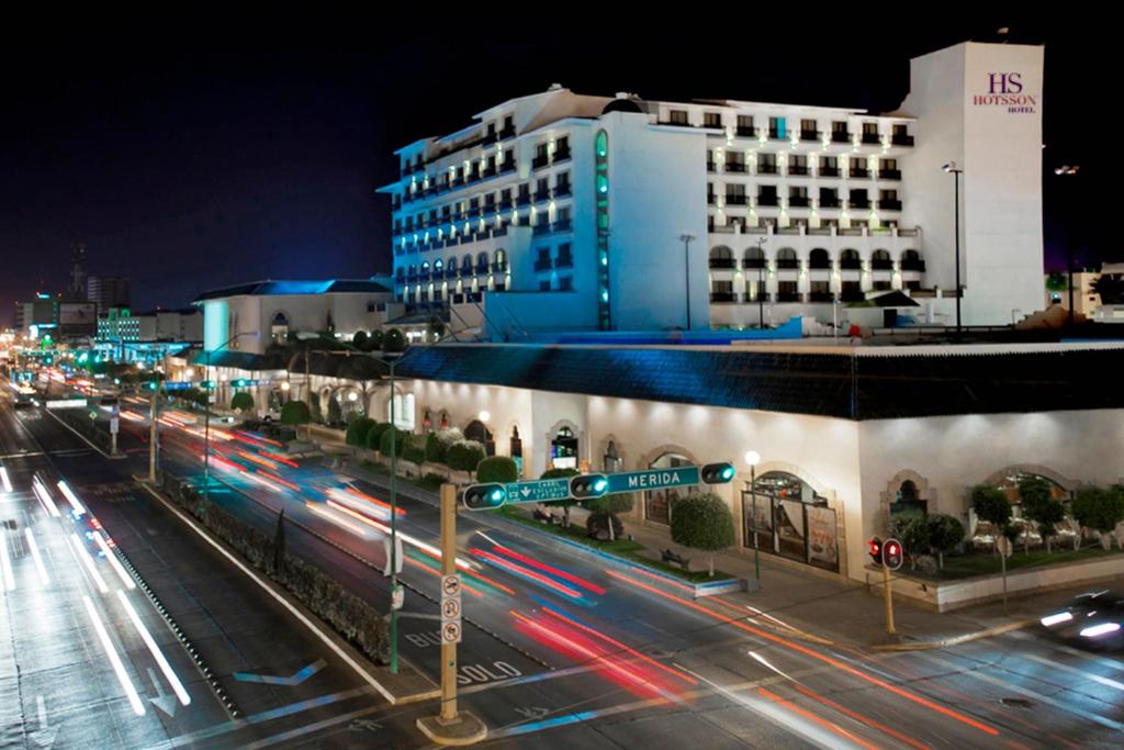 een stadsstraat 's nachts met verkeerslichten en een gebouw bij HS HOTSSON Hotel Leon in León