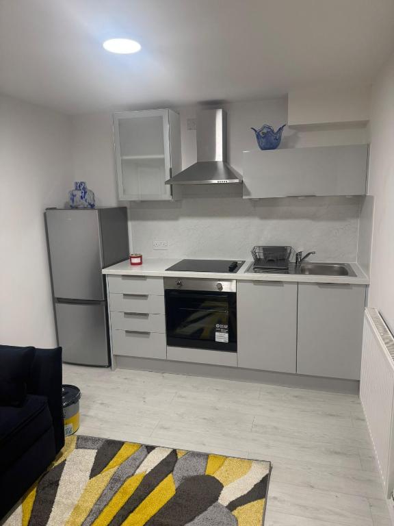 a kitchen with a sink and a stove top oven at Cozy Lodge in Rochester