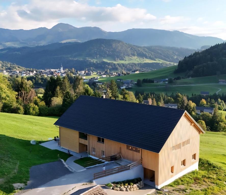 an aerial view of a barn with mountains in the background at Haus Lang in Hittisau