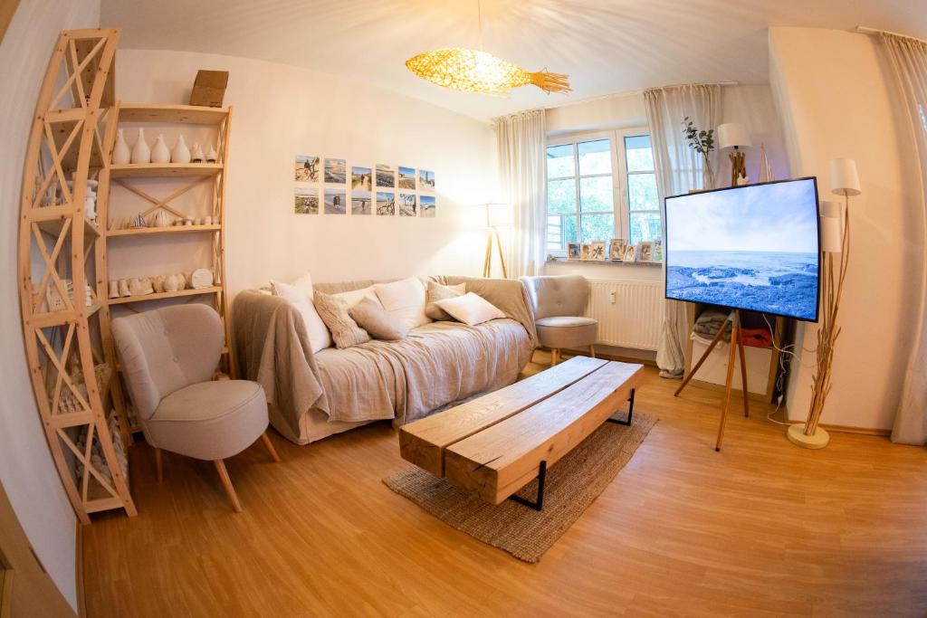 a living room with a couch and a flat screen tv at Apartment in Prerow with terrace & close to the beach in Prerow