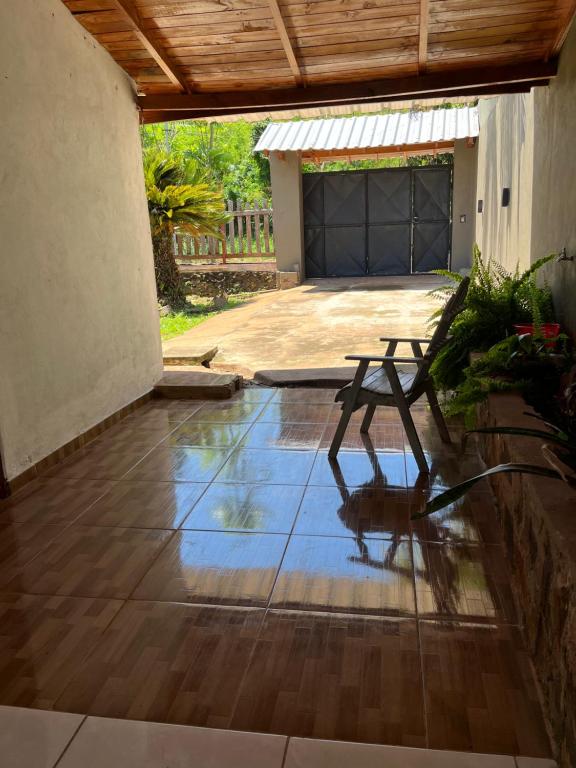 a patio with a picnic table in front of a garage at alojamiento lolita in Puerto Iguazú