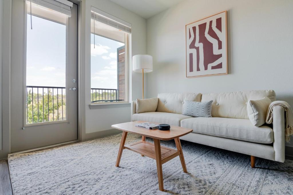 a living room with a couch and a table at Blueground Del Valle pool nr McKinney Falls ATX-353 in Austin