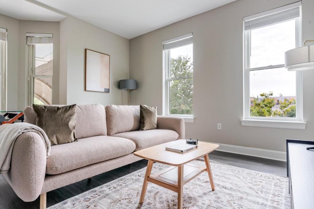 a living room with a couch and a table at Blueground Bethesda fitness center nr Park WDC-1191 in Bethesda