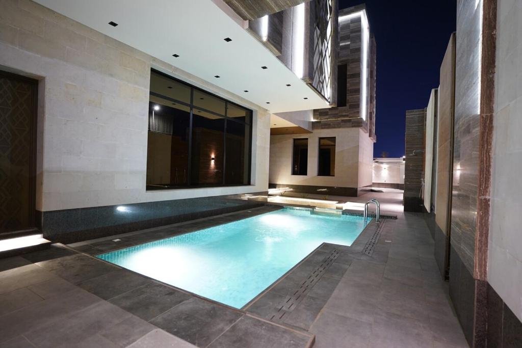 a swimming pool in the middle of a house at Villa, 6BR with swimming pool next to Stars avenue in Jeddah