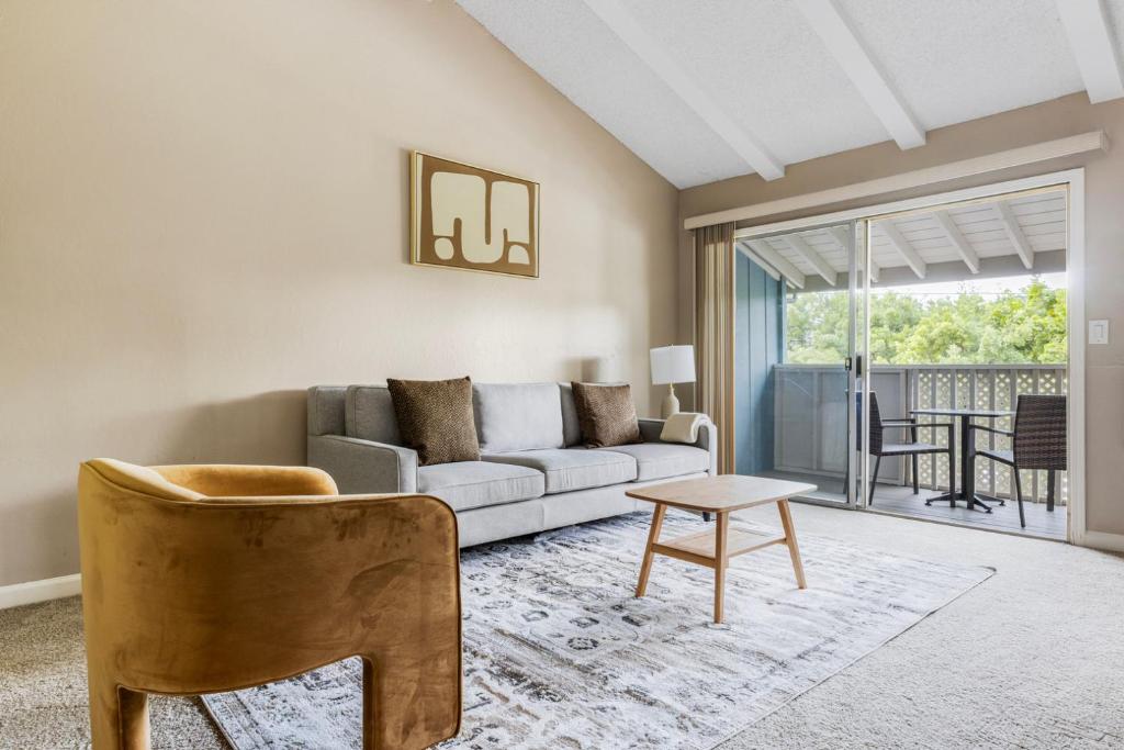 a living room with a couch and a table at Blueground West Valley pool nr Memorial Park SFO-2051 in Rancho Rinconada
