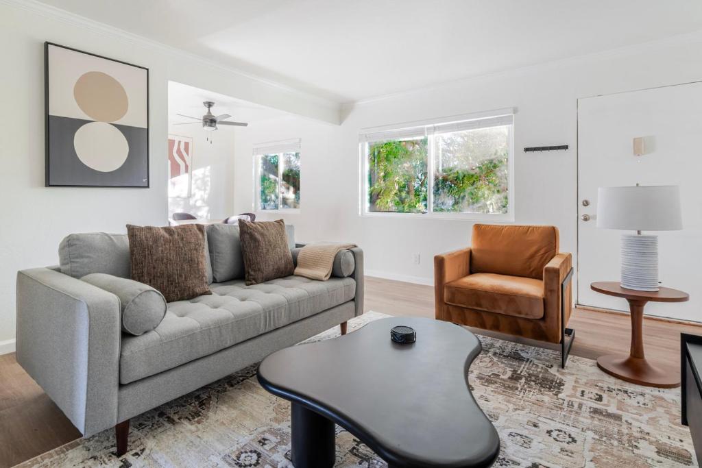a living room with a couch and a chair at Blueground Old Mountain View pool nr Park SFO-2037 in Mountain View