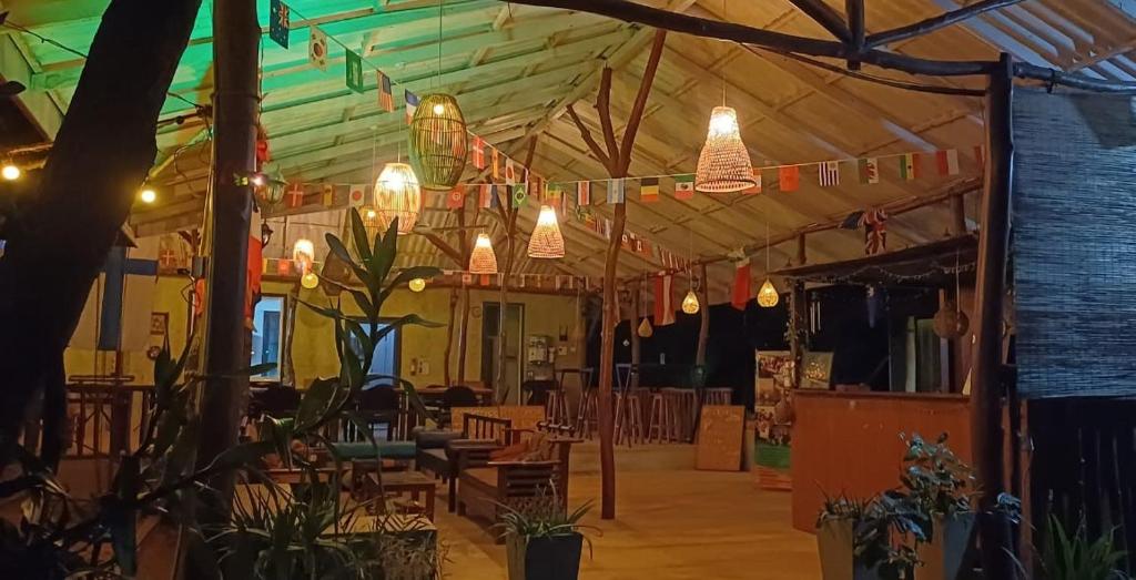 a restaurant with lights hanging from the ceiling at GreenSenz Resort & Hostel-Sigiriya in Sigiriya
