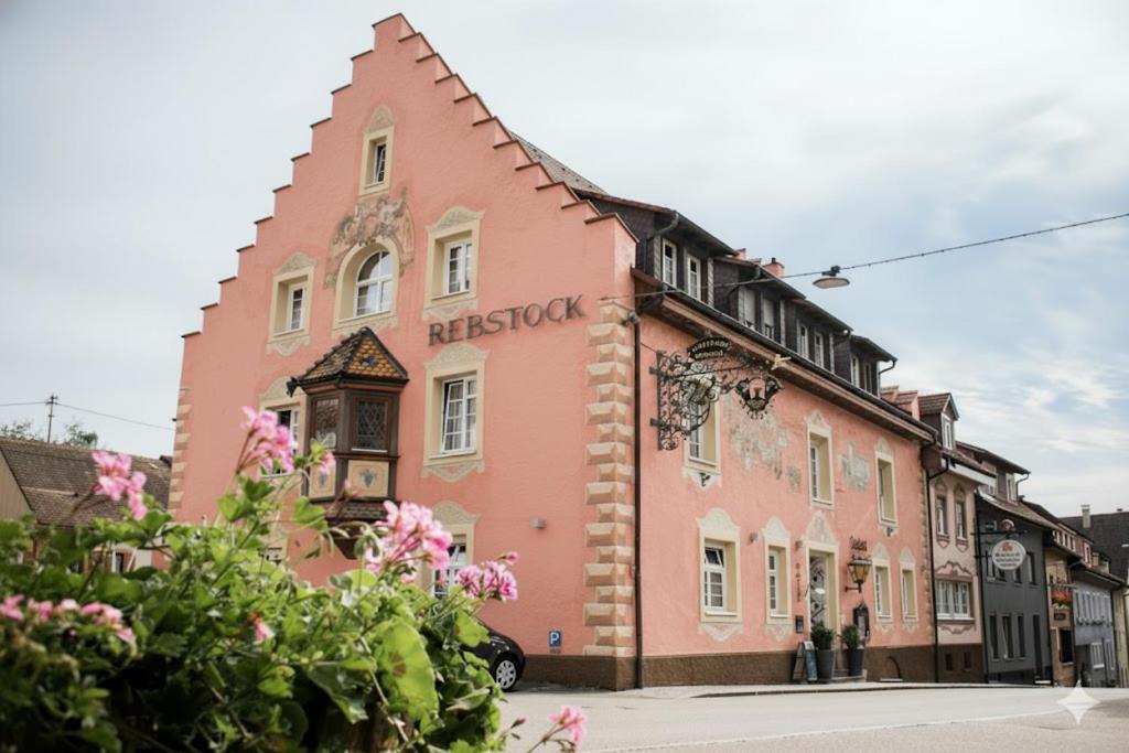 a pink building on the side of a street at Landgasthof Hotel Rebstock in Stühlingen
