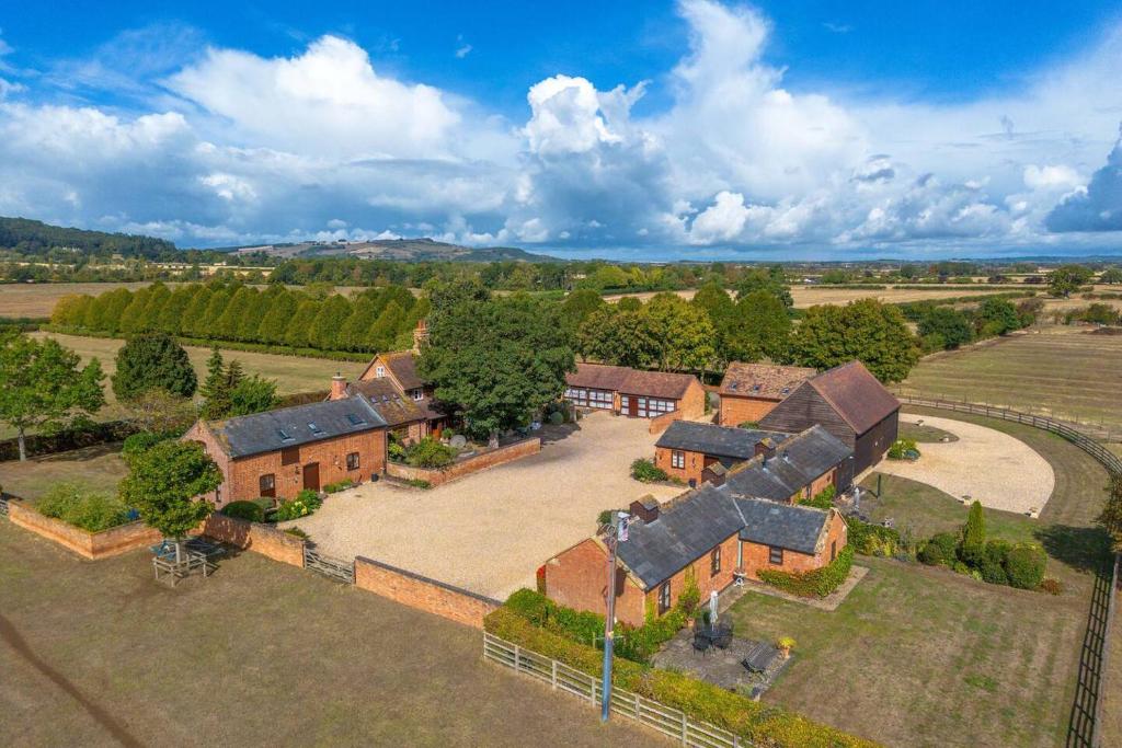 an aerial view of a house with a large yard at Cotton Farm Estate - 4 Cottages Sleeps 16 in Aston Somerville
