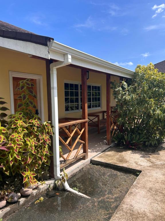 a house with a porch with a wooden gate at Yoga Dreams Negril in Negril