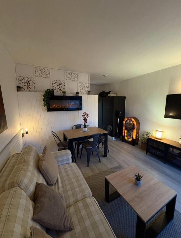 a living room with a couch and a table at cosystudio Superdevoluy 5pers pied des pistes in Le Dévoluy