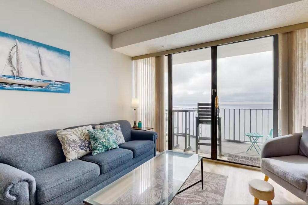 a living room with a couch and a view of the ocean at Relaxing Oceanfront 2BR Beach Condo! Royal Garden 1514 in Myrtle Beach