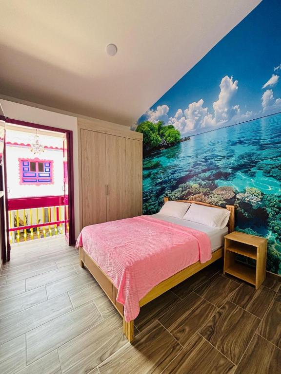 a bedroom with a mural of the ocean at Jardinhabs - JARDÍN in Filandia