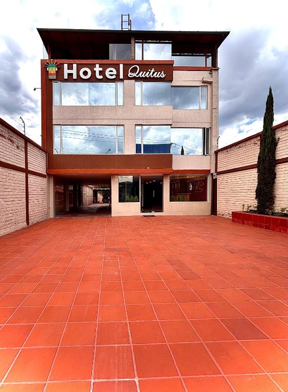 a hotel with a sign on the front of a building at Hotel Quitus Airport in Quito