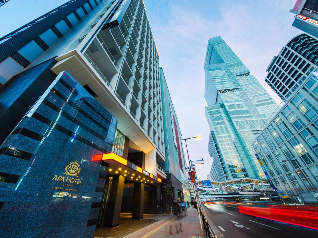 a city with tall buildings and a street with cars at APA Hotel Tennoji Ekimae in Osaka