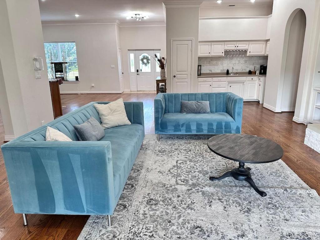 a living room with a blue couch and a table at Luxury Event and Stay in Celina, Texas in Gunter