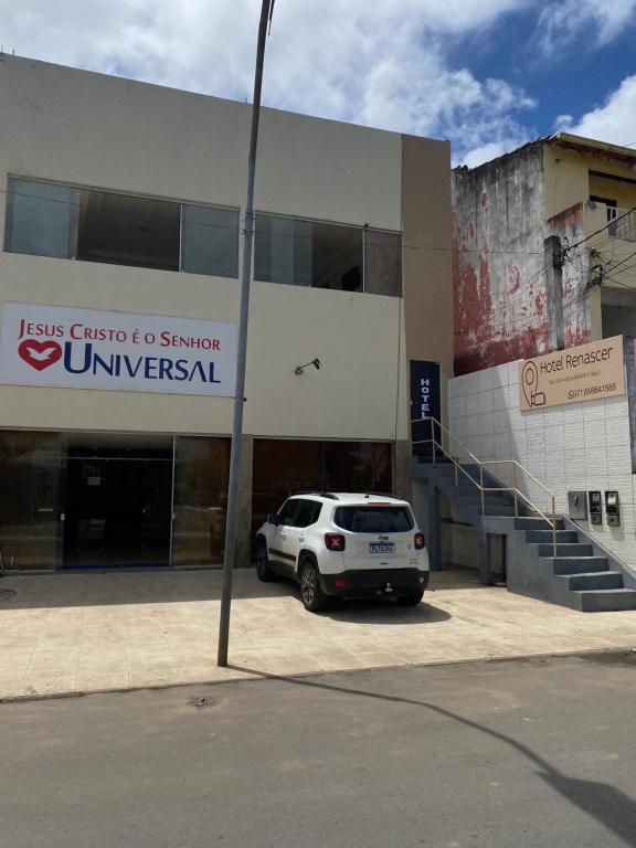 a white car parked in front of a building at Hotel Renascer pojuca in Pojuca