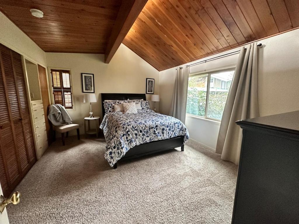 a bedroom with a bed and a window at Medford Home And 2 Condos With Pool in Medford