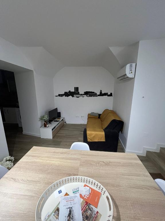 a living room with a table and a couch at Casa dos Albardeiros in Moura