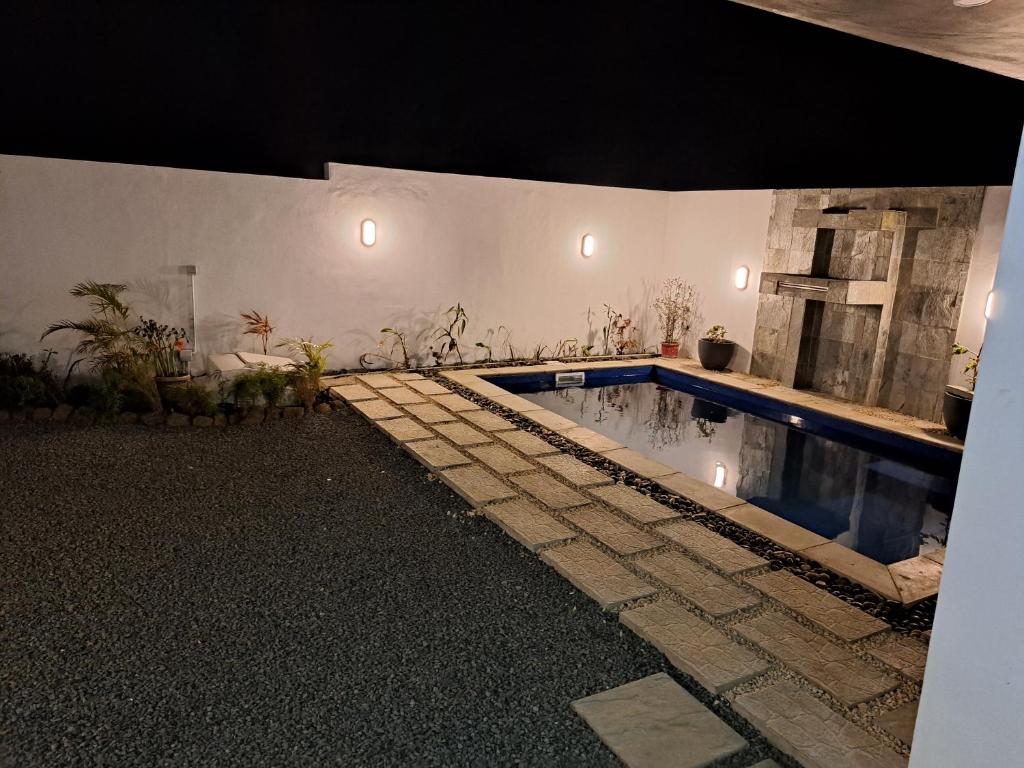 a swimming pool in a white room with at Marbella villas 2 in Grand Baie