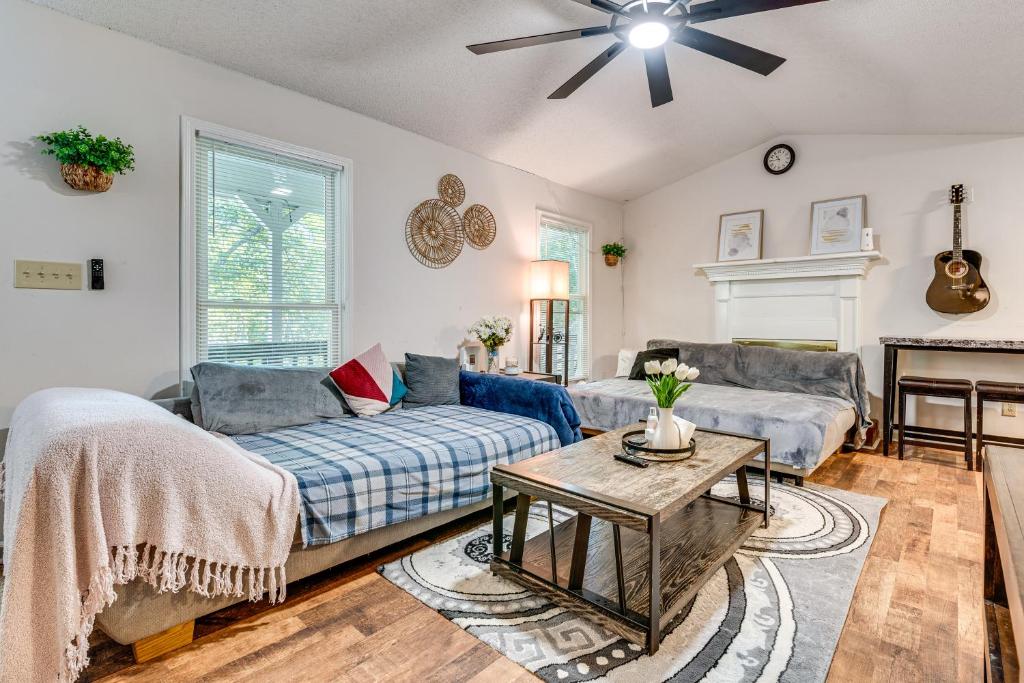 a living room with a couch and a table at Easy I-20 Access to ATL Suburban Retreat with Yard in Douglasville