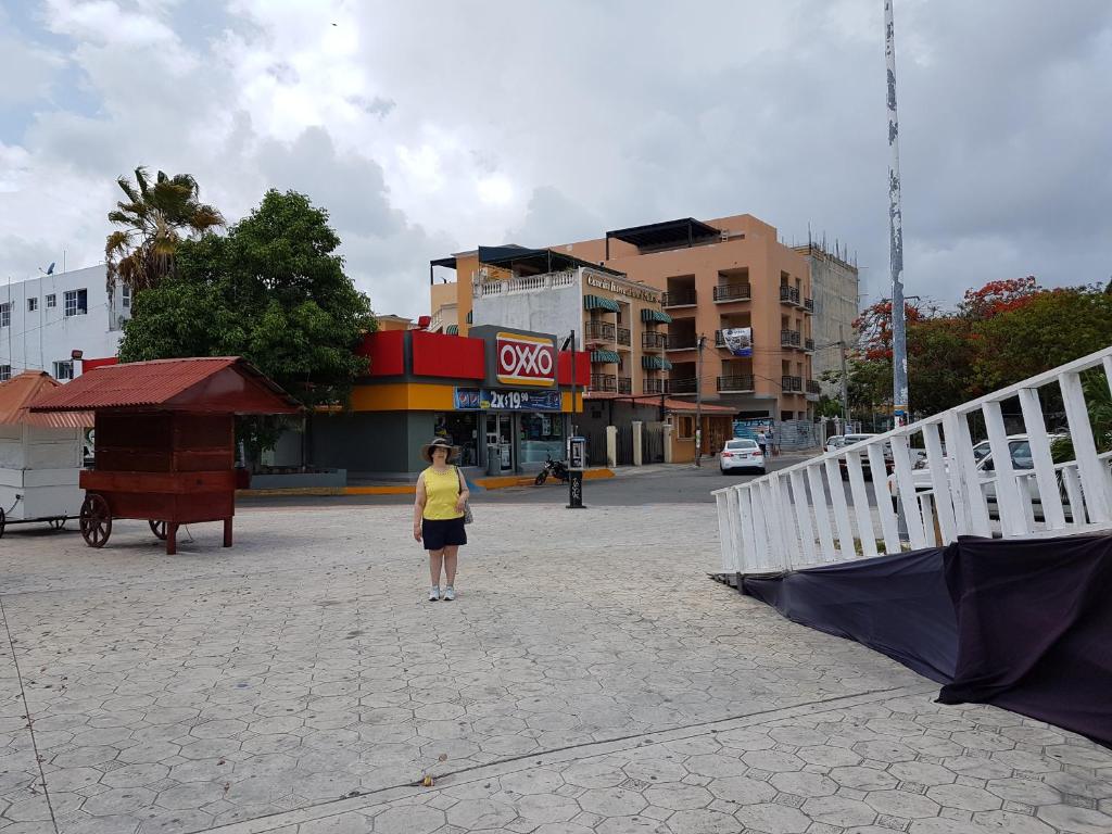 a woman standing in the middle of a street at Villa del Palmar in Cancún
