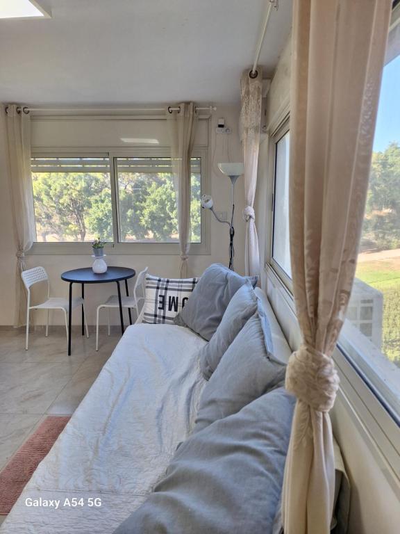 a bed in a room with a window at Charming beach 2 room flat in Haifa