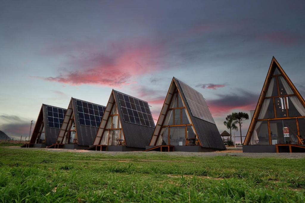 a group of triangular buildings with solar panels at Mont Hermon Hotel Castro in Castro