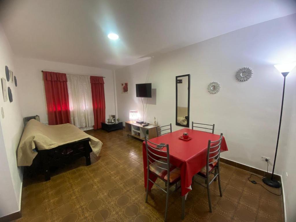 a living room with a red table and chairs at Olivos Stay in Olivos