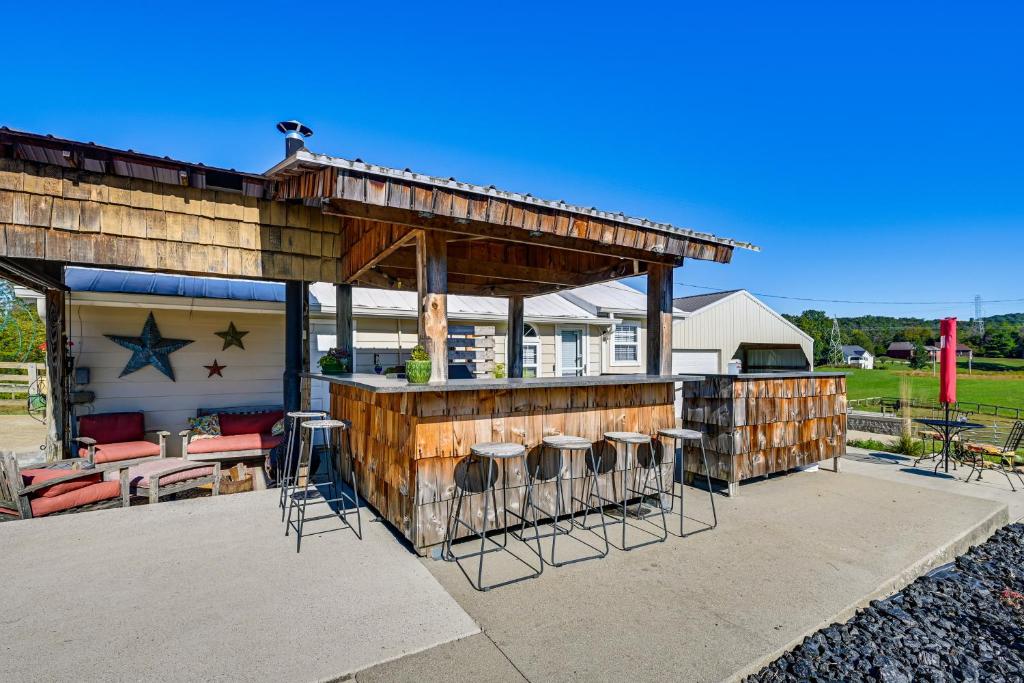 a house with a bar and stools on a patio at 11 Mi to Lake Cumberland! Retreat with Gazebo in Somerset