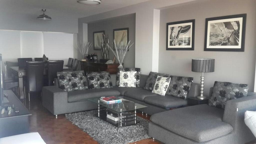 a living room with a couch and a table at Durban Penthouse in Durban