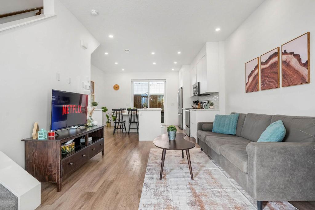 a living room with a couch and a table at Inner-City Chic Urban Farmhouse 3 Bds and Ba in Calgary