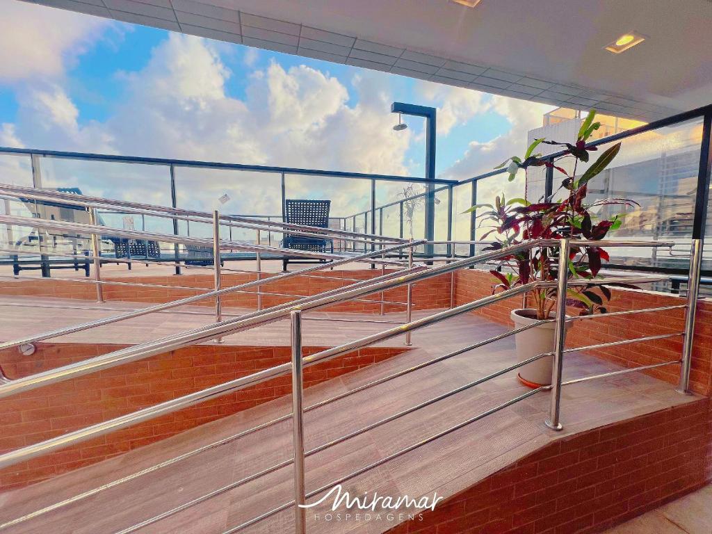 a balcony on a ship with a plant on it at Beach Way c/Piscina na cobertura-Miramar Hospedagens in João Pessoa