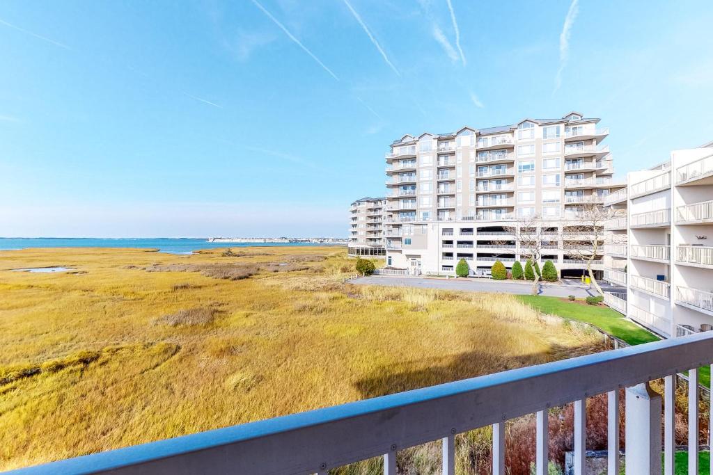 a view of the beach from the balcony of a building at Triton's Trumpet B 303 in Ocean City