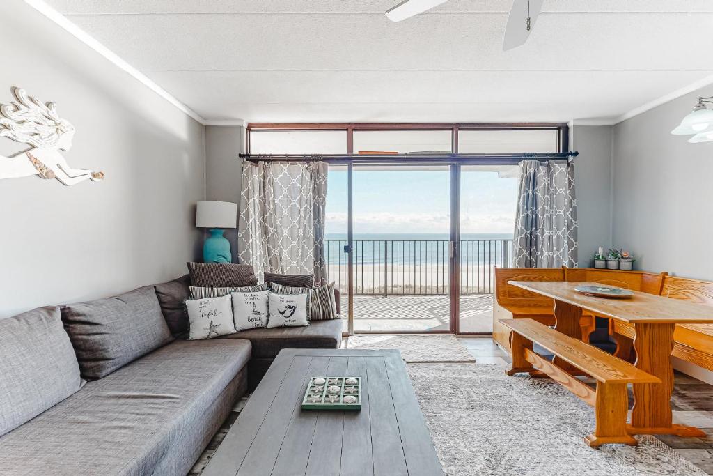 a living room with a couch and a table at Sails II 502 in Ocean City