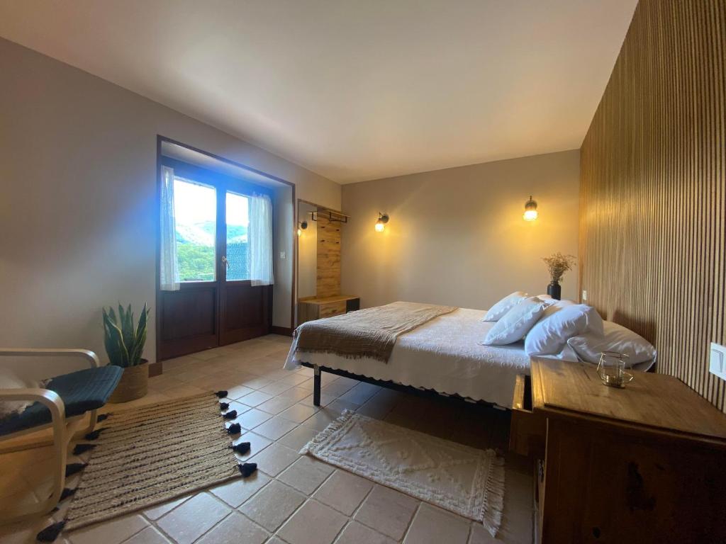 a bedroom with a large bed and a window at casa rural larre aundi in Rentería