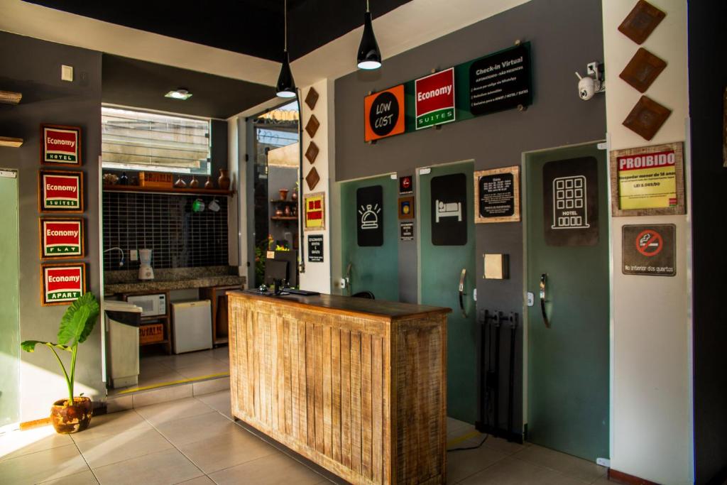 a restaurant with a counter and signs on the wall at Economy Suites in Natal