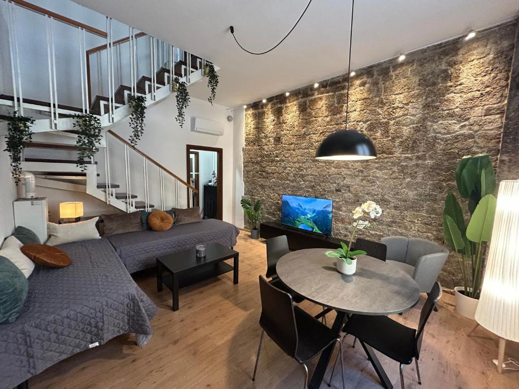 a living room with a couch and a table at The Loft in Pisa