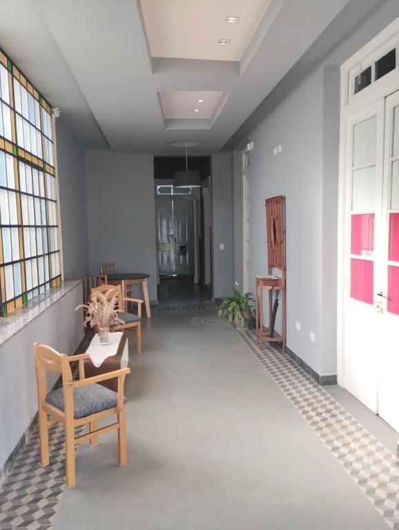 a hallway with chairs and a table in a building at La Casona Apart Boutique in Marcos Juárez