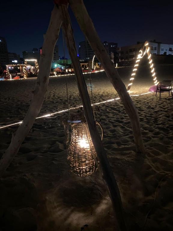 a hanging chair on the beach at night at Miral Camp in Nuweiba
