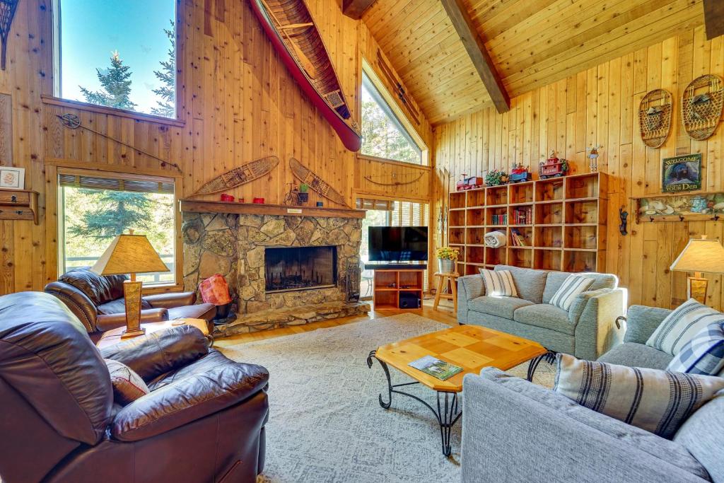 a living room with couches and a fireplace at Game Room and Views Cabin Near Purgatory Resort! in Durango Mountain Resort