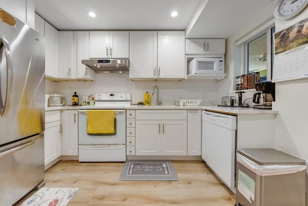 a kitchen with white cabinets and white appliances at Cool & Private 3BR 3BA Near Airport Strong AC in Richmond