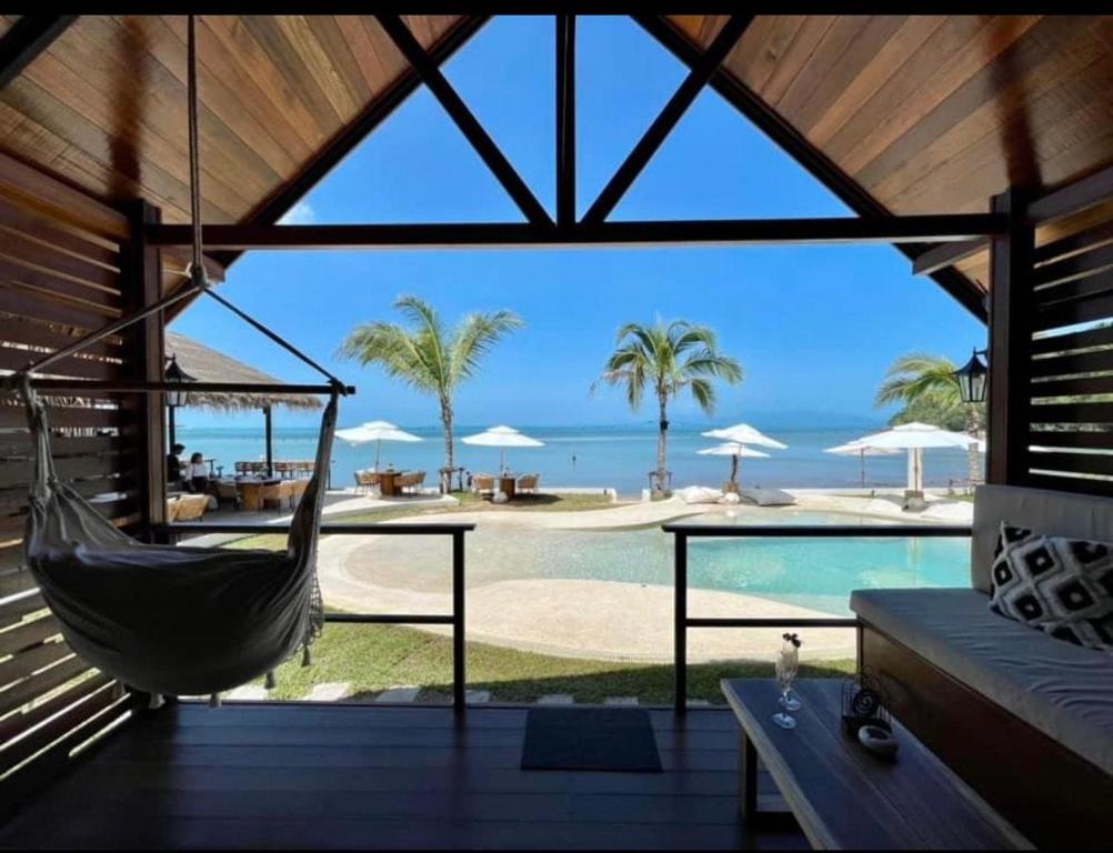 a porch with a hammock and a view of a pool at Azul Beach Resort in Bophut