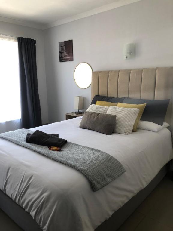 a bedroom with a large bed with two pillows on it at Relaxing Hideaway in Strand