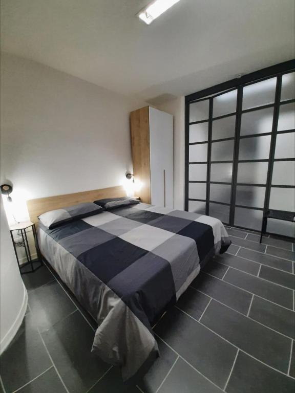 a large bed in a room with a large window at La Stella Bianca in Sutri