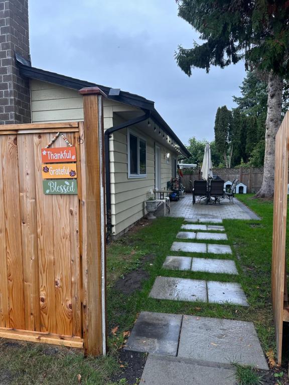 a fence with a sign on it next to a house at Sunny Nook in Richmond