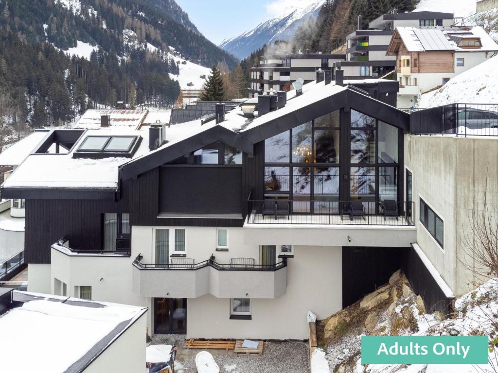 a house in the mountains with snow at Adult Only Superior Suite in Niederhof